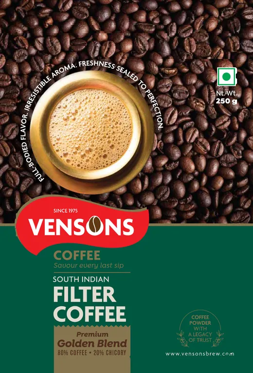 Vensons Premium Golden Blend 250 g pack, dark green with a brass filter coffee tumbler on roasted beans